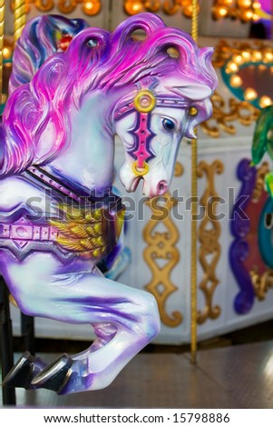 A colorful horse close-up on a carousel at the fair ground