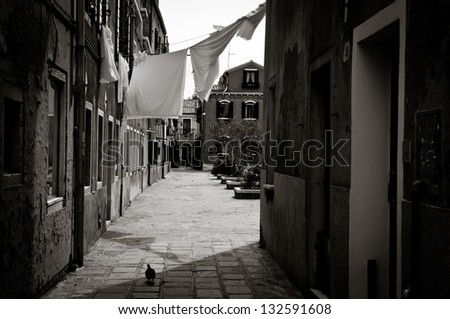 A black and white picture of an old alley on Burano island, italy