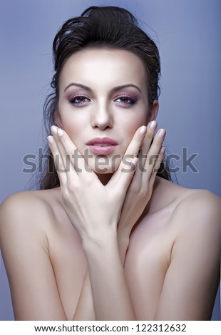 beautiful model with long hair posing fashion in studio with butterfly fingers