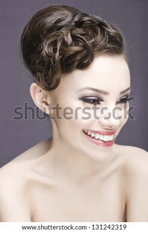 Seductive girl super model  smiling in studio with hairstyle