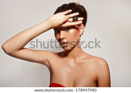 Seductive girl super model with jewelry posing in studio over background