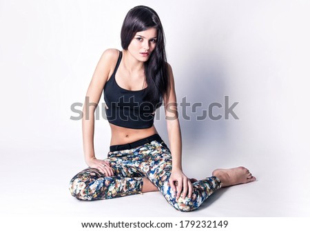 Seductive girl super model posing in studio over white background,standing down