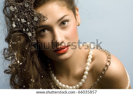 beautiful model with long hair and  star and pearls posing fashion in studio