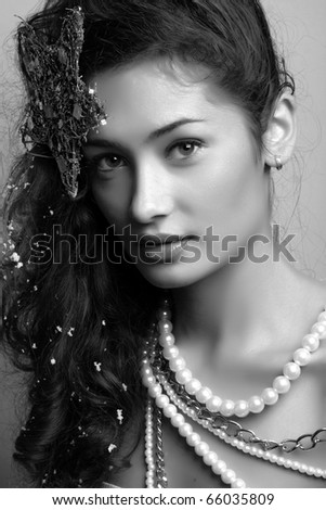 beautiful model with long hair and  star and pearls posing fashion in studio