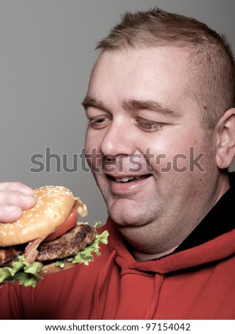 Chubby man eating burger