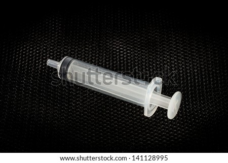 Syringe on black background. Medical syringe.