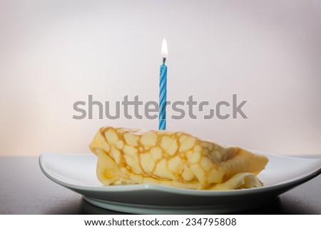 Dessert crepes on a white plate. Crepe Cake Candle.