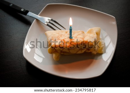 Dessert crepes on a white plate. Crepe Cake Candle.