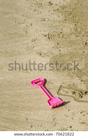 Plastic toys on the beach. Toy shovels.