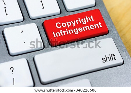 Written word Copyright Infringement on red keyboard button. Online Protection and Internet Security Concept.