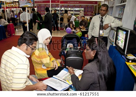 KUALA LUMPUR, MALAYSIA - MARCH 24 : Parents looking for the best in education for their newborn babies during the Kuala Lumpur International Book Fair March 24, 2010 in Kuala Lumpur Malaysia.