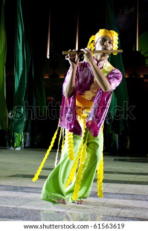 PUTRAJAYA, MALAYSIA - MAY 25 : A young musician from the Orang Asli community performing a dance during the rehearsal of Colours of Malaysia Festival May 25, 2007 in Putrajaya Malaysia.