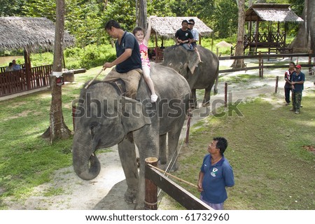 KUALA GANDAH, MALAYSIA - SEPTEMBER 25 : Visitors to Elephant Orphanage Sanctuary was treated to an elephant ride during Elephant Awareness Program September 25 2010 in Kuala Gandah, Malaysia.
