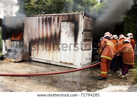 KUALA LUMPUR, MALAYSIA - FEB 23:  Participants with the guidance from Fire and Rescue Department putting out a fire during a Fire Awareness and Safety Day on February 23, 2011 in Kuala Lumpur Malaysia