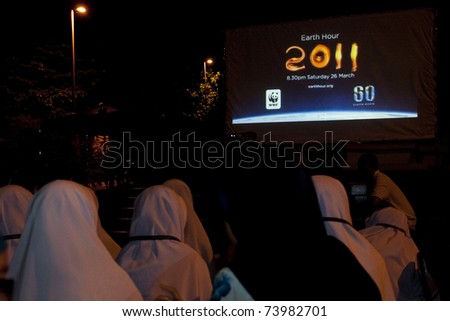 KUALA LUMPUR, MALAYSIA-MAR 26: Participant of Earth Hour Campaign watch a documentary on Mar 26, 2011 in Kuala Lumpur.More than 4,000 cities in 131 countries celebrate Earth Hour