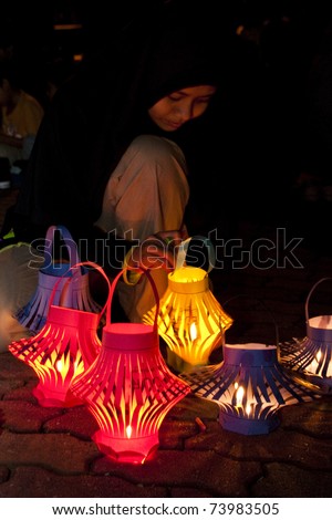 KUALA LUMPUR, MALAYSIA-MAR 26:An unidentified woman lights-up lantern during Earth Hour Campaign on Mar 26, 2011 in Kuala Lumpur.More than 4,000 cities in 131 countries celebrate Earth Hour