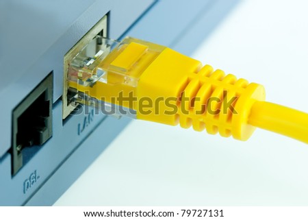 Close up Detail of  RJ45 Yellow Network Cable Connected To Wireless Router