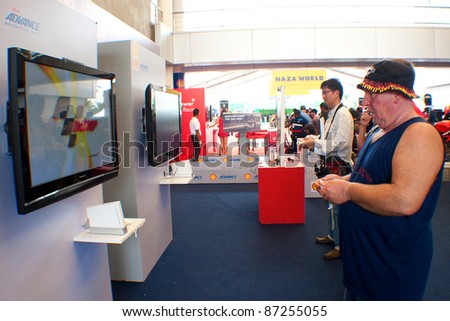 SEPANG, MALAYSIA - OCT 21: Unidentified fans play interactive MotoGP Games during test day at the Malaysian Motorcycle Grand Prix 2011 on October 21, 2011 in Sepang, Malaysia.