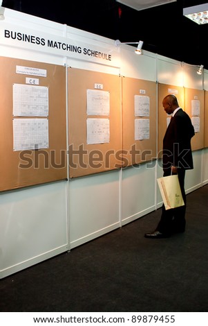 KUALA LUMPUR-NOV 23: Unidentified Investor browsing the business matching schedule at INTRADE2011 on November 23, 2011 in Kuala Lumpur, Malaysia. INTRADE2010 recorded RM234.69 million in actual sales.