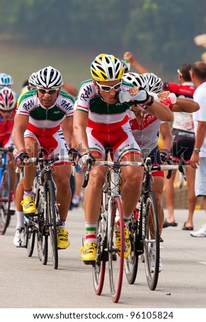 PUTRAJAYA, MALAYSIA - FEB 18: Unidentified cyclists from Iran team drink water in the Elite Men\'s Road Race at the 32nd Asian & 19th Junior Asian Cycling Championships on Feb 18, 2012 in Putrajaya, Malaysia.