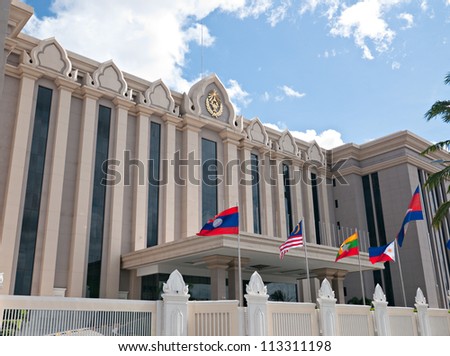 The Peace Palace, one of several government buildings along Confederation de la Russie in Phnom Penh, Cambodia. The building is financed by the Chinese government. Flags of ASEAN nations.