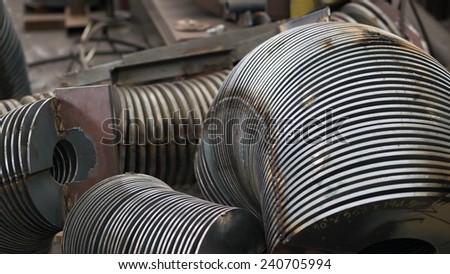 Steel parts for screw conveyors at an early production stage. Shallow depth of field.