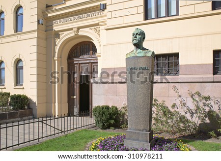 Oslo, Norway - April 21, 2015: Behind these doors, at The Norwegian Nobel Institute, the decision is made every year who will receive the Nobel Peace Prize. A bust of Alfred Nobel in the foreground.