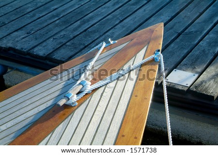 Bow of classic, wooden sailboat with teak-deck