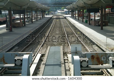 Empty railway tracks between the platforms of a big railway station. Oslo Sentralbanestasjon, Oslo, Norway.