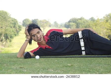 Young, female, Asian golf player resting at the tee-box