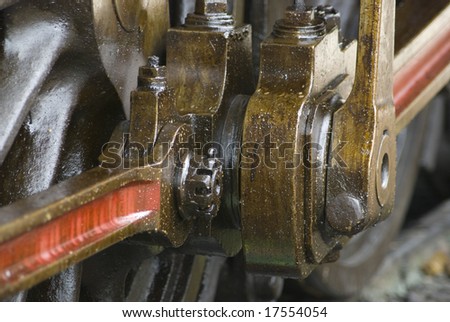 Detail of running gear of old steam engine stained by oil used for lubrication.