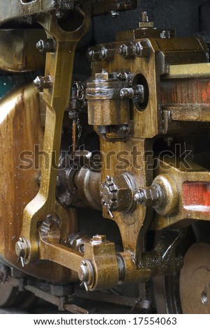 Running gear of old steam engine stained by oil used for lubrication.