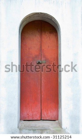 Old, tall, red door at the Temple of Literature, Van Mieu, in Hanoi.