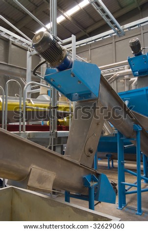 Production machinery at processing plant. Factory interior