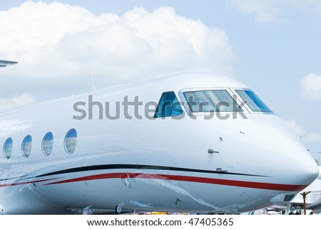 Front section of white executive jet with oval windows