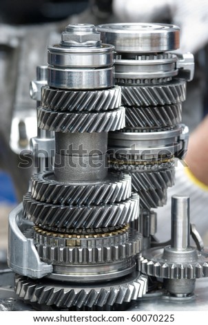 Assembly of a car gearbox. Shallow depth of field with the first group of gears in focus.