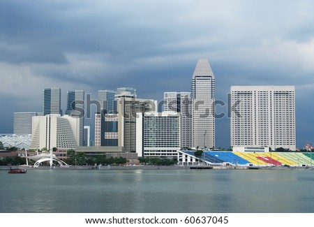 Singapore skyline, Marina Square and Esplanade area, with hotels and dark clouds in the background.