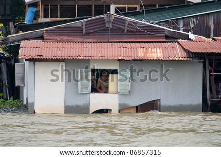 BANGKOK, THAILAND - OCTOBER 17: Flooded community along Chao Praya River during the worst flooding in decades in Bangkok, Thailand on October 17, 2011.