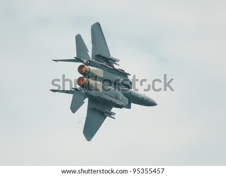 SINGAPORE - FEBRUARY 16: F15 fighter jet showing its capabilities during Singapore Airshow at Changi Exhibition Centre in Singapore on February 16, 2012.