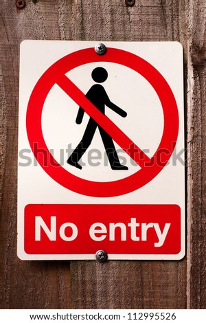 No entry sign  The sign is a universal red colored round circle with a person inside.  There is a diagonal red line through the person and the words NO ENTRY underneath