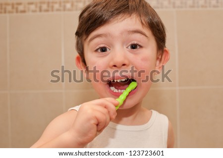 Cute boy washing his teeth. it is important to teach children from an early age the importance of oral hygiene.
