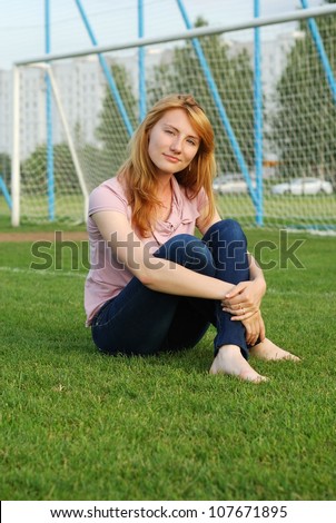 The beautiful girl on a football ground