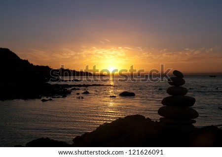 Stones balanced at sunset