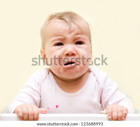 Portrait of crying baby girl.