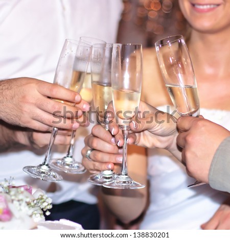 Group of people toasting with champagne at wedding.
