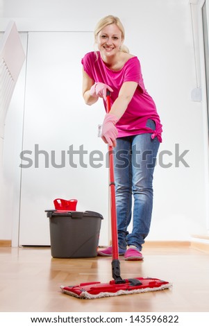 Young Woman Cleaning And Mopping Floor At Home.