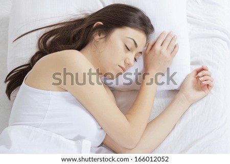 Beautiful young woman sleeping in the bed.