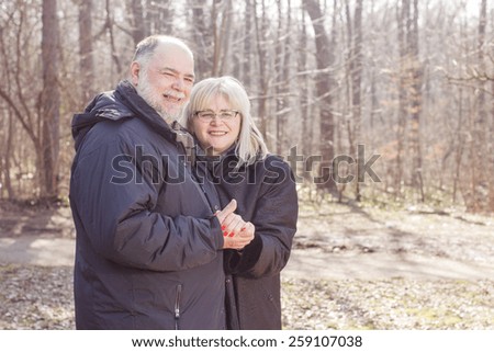 Happy Elderly Senior Romantic Couple in nature, Old people portrait outdoor winter autumn season.