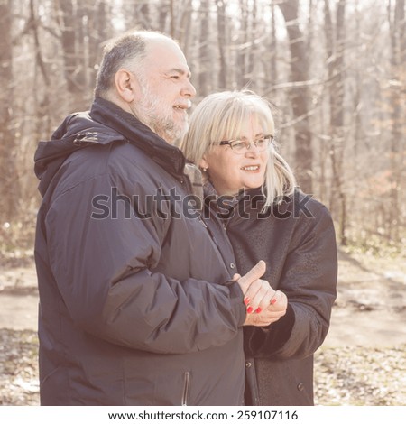 Happy Elderly Senior Romantic Couple in nature, Old people portrait outdoor winter autumn season.