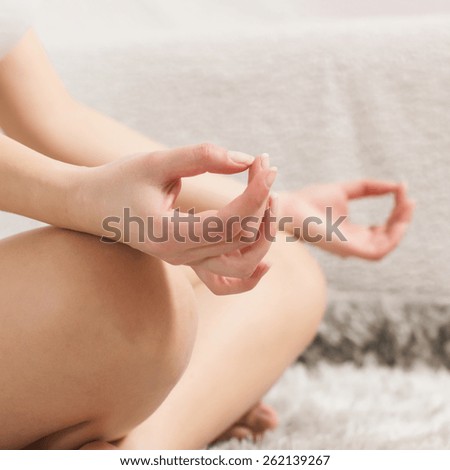 Yoga Woman Meditating Relaxing at home.Close-up of unrecognizable female hand in lotus posture. Healthy Lifestyle.